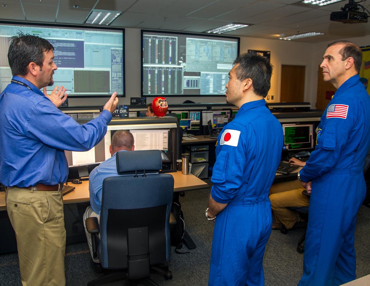 NASA Astronaut Rick Mastracchio and JAXA Astronaut Koichi Wakata visit the Earth Science Division at the Goddard Space Flight Center in the GPM control room with James Pawloski